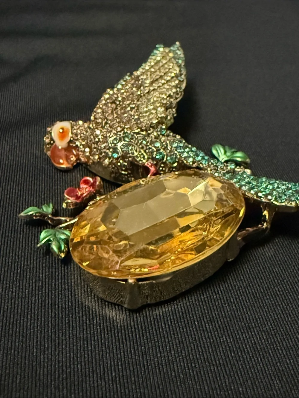 vintage-inspired green crystal parrot brooch with yellow stone